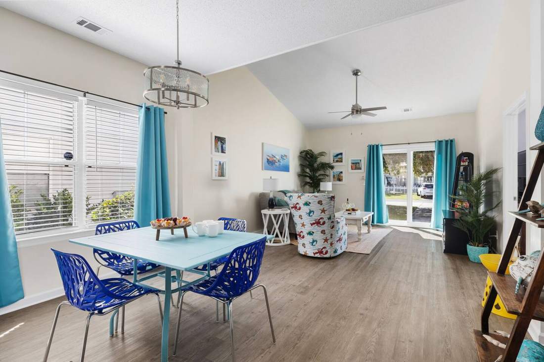 Open dining and living area with teal curtains