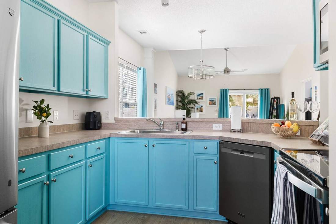 Teal kitchen with full-size appliances and dishwasher